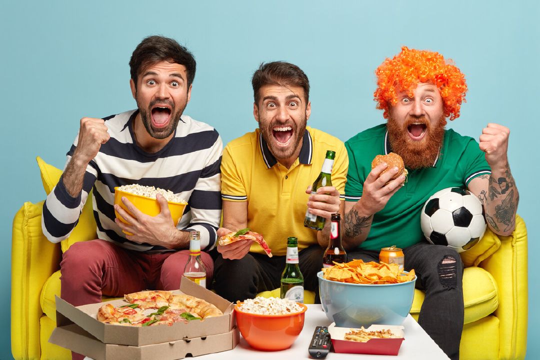 images/happy-three-friends-being-football-fans-watch-soccer-pose-sofa-living-room-eat-fast-food-drink-cold-beer.jpg